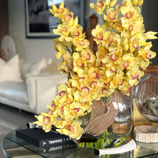 Cymbidium-Orchideenarrangement in Gelb mit Mondvase